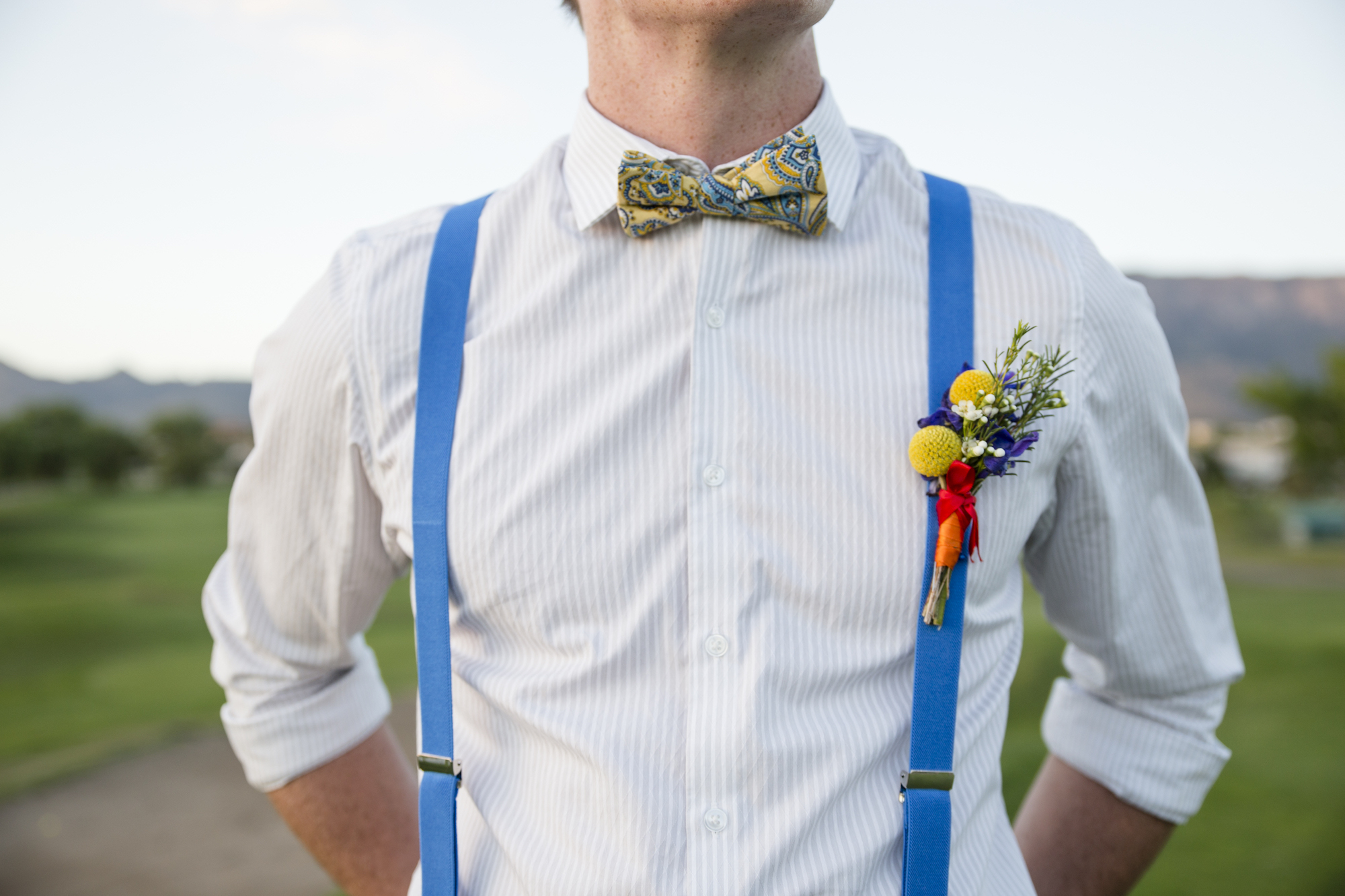 wedding planning design decor inspo real local New Mexico Perfect Wedding Guide couple bright color blue orange red hot air balloon love suspenders mens fashion bowtie paisley greenery detail outdoor romantic
