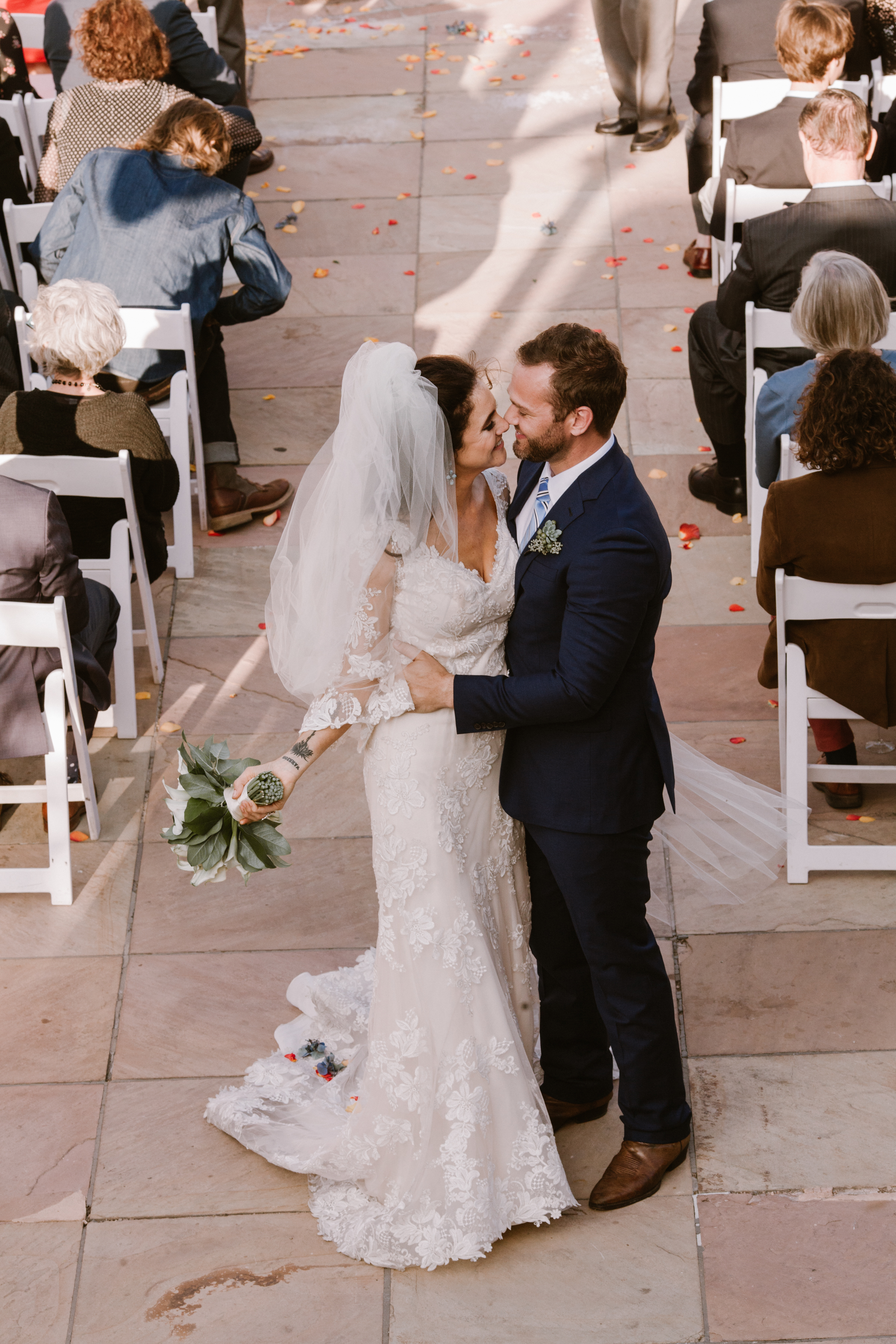 New Mexico wedding Santa Fe planning La Fonda gown suit inspiration design floral bouquet lace photography romantic styled local perfect wedding guide lilies ceremony outdoor greenery natural light Birdseye couple vows flower petals