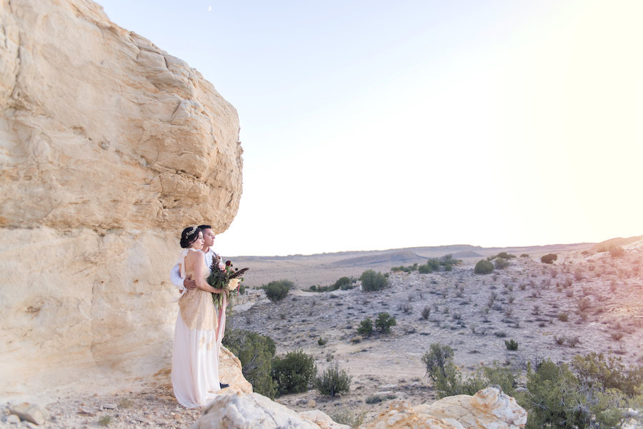 wedding planning photography styled shoot natural light outdoor elopement engagement New Mexico Albuquerque mountains Perfect Wedding Guide landscape unique nature inspiration couple bridal gown gold details bouquet desert Southwestern