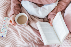 Bride to be enjoying alone time while drinking tea or coffee while reading a book.