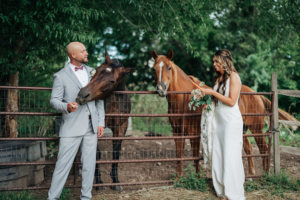 Colorado couple elopes for their wedding. Feeding horses in their formal wear.